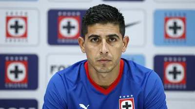 A determined, 28-year-old Cruz Azul sporting director, in a blue and red home kit with the Cruz Azul crest on the chest...