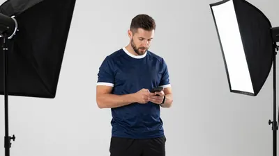 A 30-year-old male coach with a rugged face, wearing a dark blue jersey with a white collar and sleeves, and a pair of...