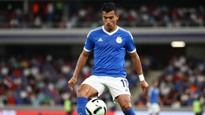 A photorealistic image of an anonymous Mexican player in his 20s, wearing a blue jersey with a white stripe, a white pair...